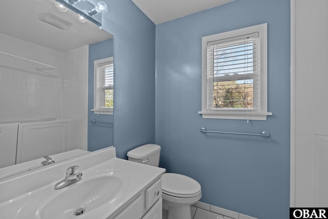 bathroom featuring vanity, toilet, and baseboards