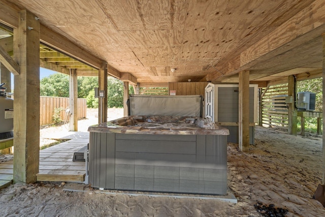 exterior space with an outdoor structure, a hot tub, and a wooden deck