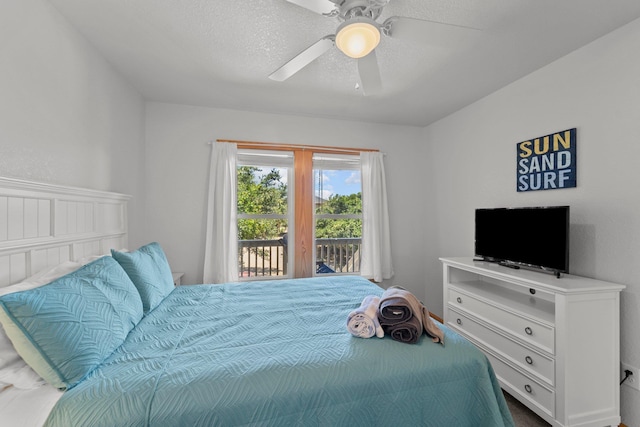 bedroom with ceiling fan, access to outside, and a textured ceiling