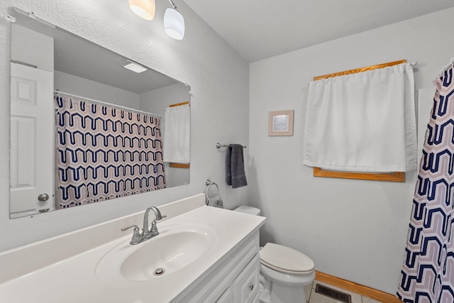 full bathroom with baseboards, visible vents, vanity, and toilet