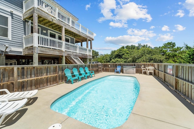 view of swimming pool featuring a patio, fence, and a fenced in pool