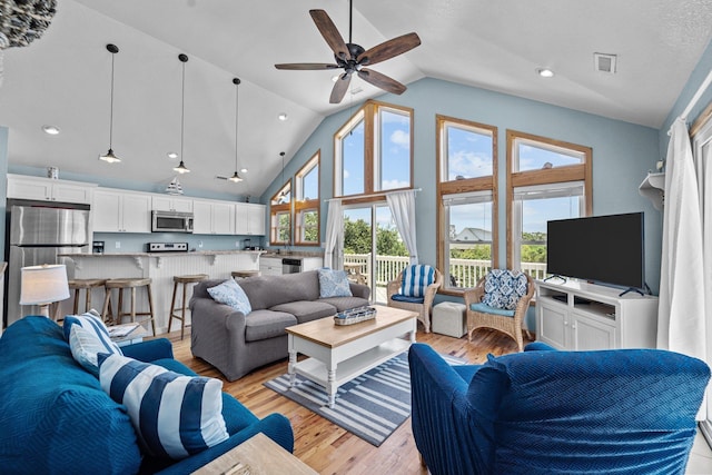 living room featuring visible vents, a ceiling fan, light wood-style flooring, high vaulted ceiling, and recessed lighting