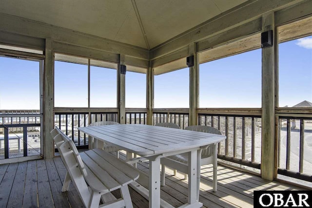 unfurnished sunroom featuring lofted ceiling