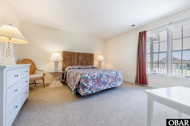 bedroom featuring light carpet, baseboards, and visible vents