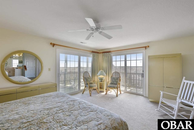 carpeted bedroom featuring a ceiling fan, access to outside, and multiple windows