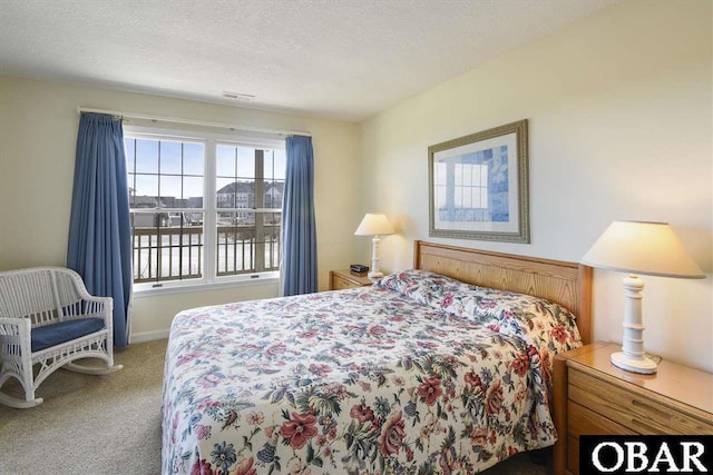 carpeted bedroom with a textured ceiling and visible vents