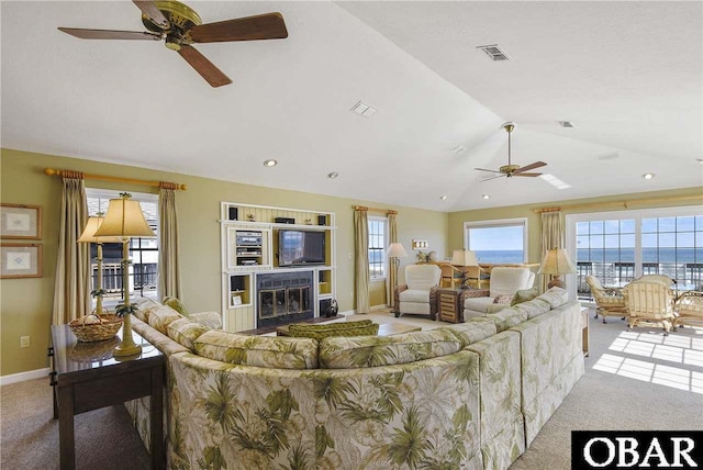 living room featuring visible vents, vaulted ceiling, light carpet, and baseboards