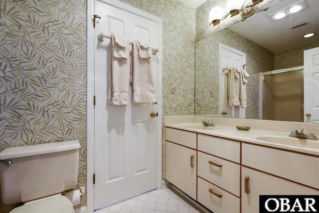 full bathroom featuring tile patterned floors, a sink, visible vents, and wallpapered walls