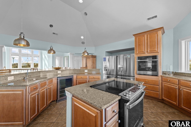 kitchen with wine cooler, visible vents, appliances with stainless steel finishes, vaulted ceiling, and a sink