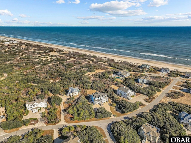 drone / aerial view featuring a view of the beach and a water view