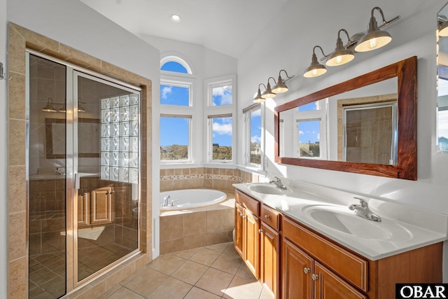 bathroom with a bath, a shower stall, and a sink