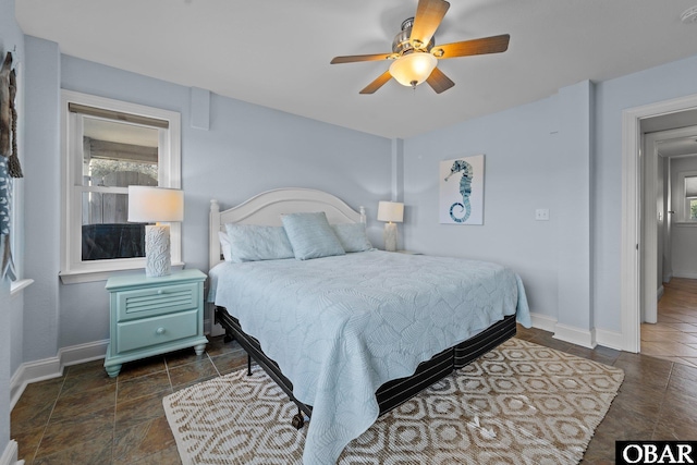 bedroom featuring ceiling fan and baseboards