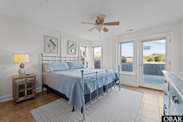 bedroom with baseboards, ceiling fan, visible vents, and access to exterior