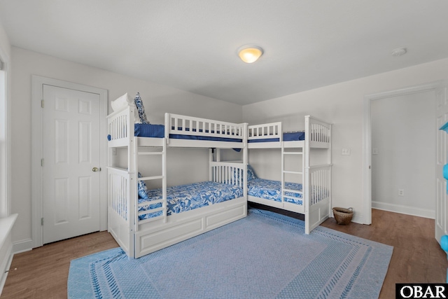 bedroom featuring baseboards and wood finished floors