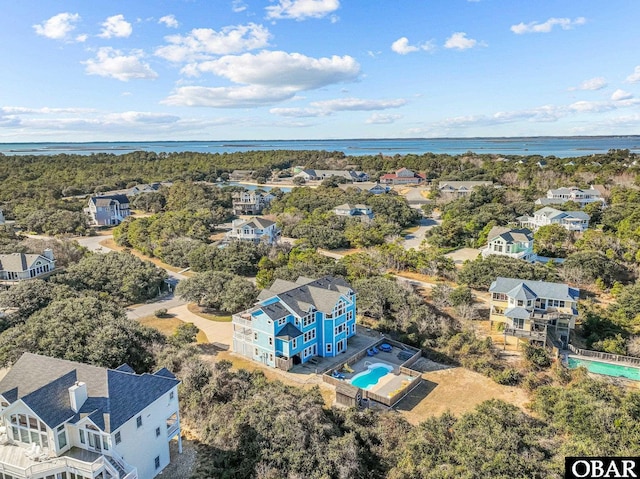 drone / aerial view featuring a water view and a residential view