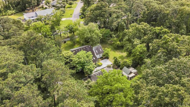 birds eye view of property with a view of trees