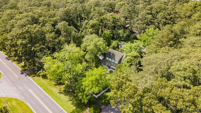 birds eye view of property with a view of trees