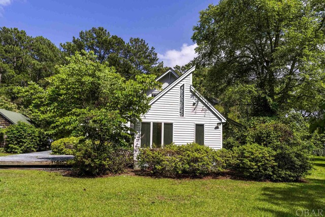 view of side of property with a yard