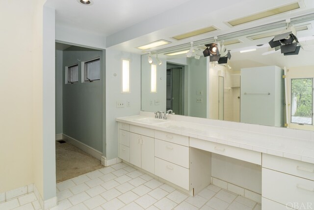 bathroom featuring vanity and baseboards