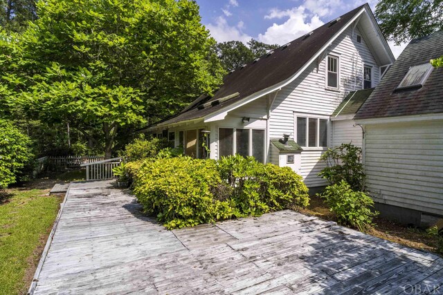 view of home's exterior featuring fence and a deck
