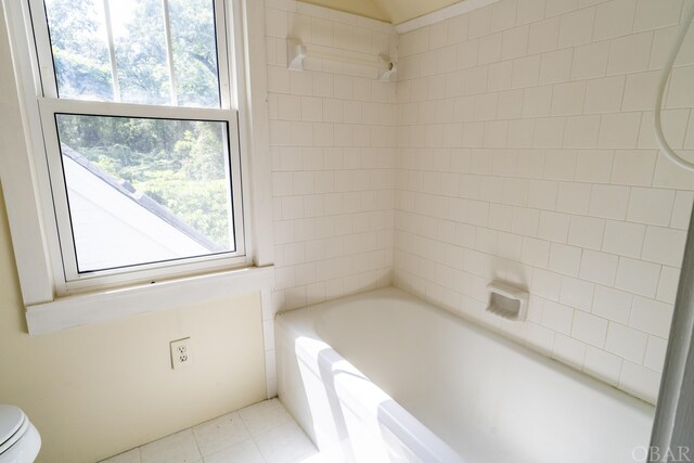 full bath with bathtub / shower combination, toilet, and tile patterned floors