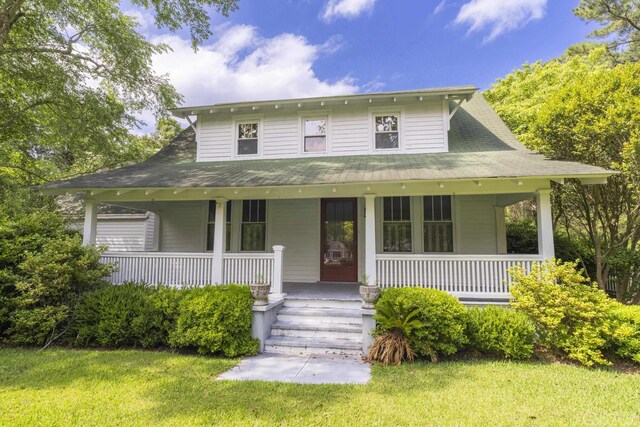 farmhouse-style home with a porch and a front yard
