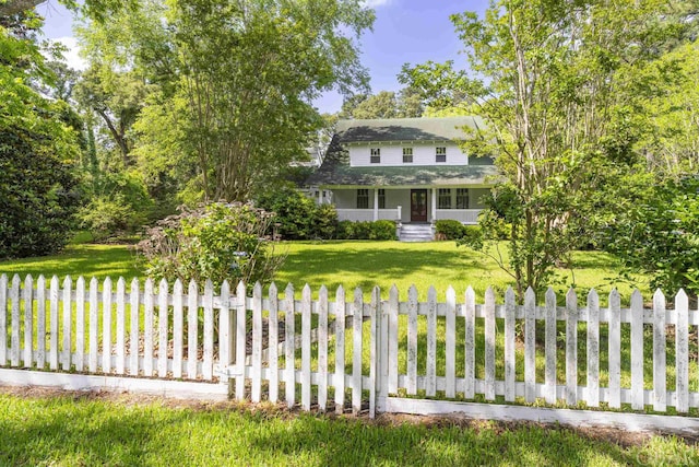 view of front of house with a fenced front yard and a front yard