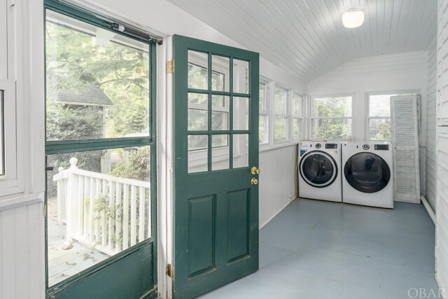 clothes washing area featuring wooden ceiling, laundry area, independent washer and dryer, and a sunroom