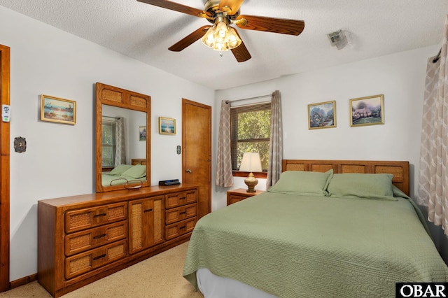 bedroom with visible vents, ceiling fan, and a textured ceiling