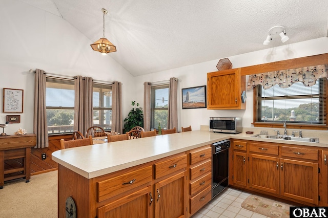 kitchen featuring a peninsula, a sink, light countertops, dishwasher, and stainless steel microwave