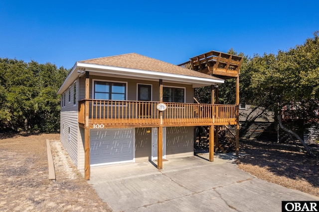 view of front of property with a garage, driveway, and a shingled roof