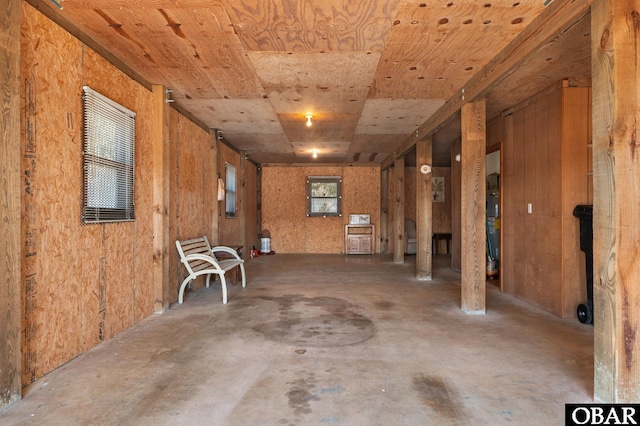 interior space with unfinished concrete flooring and wood ceiling