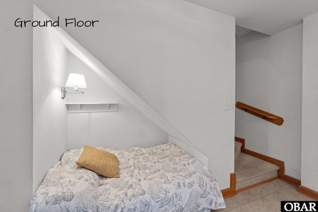 tiled bedroom featuring baseboards