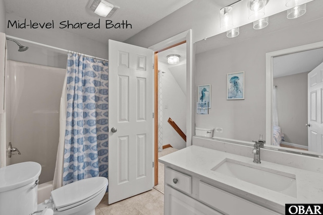 full bathroom featuring toilet, tile patterned flooring, and vanity