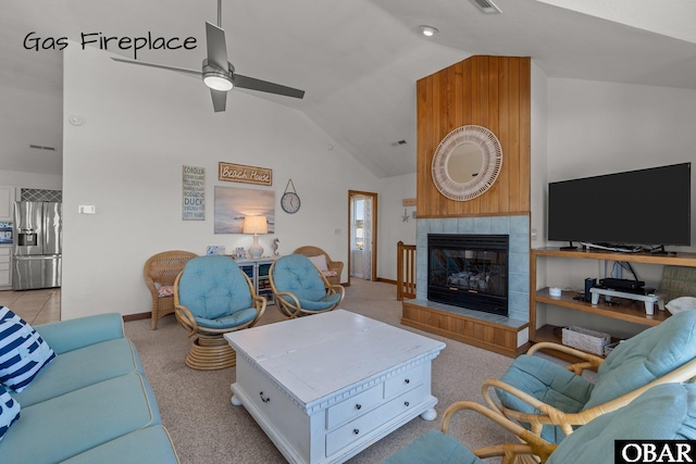 living room with a tiled fireplace, ceiling fan, vaulted ceiling, and baseboards