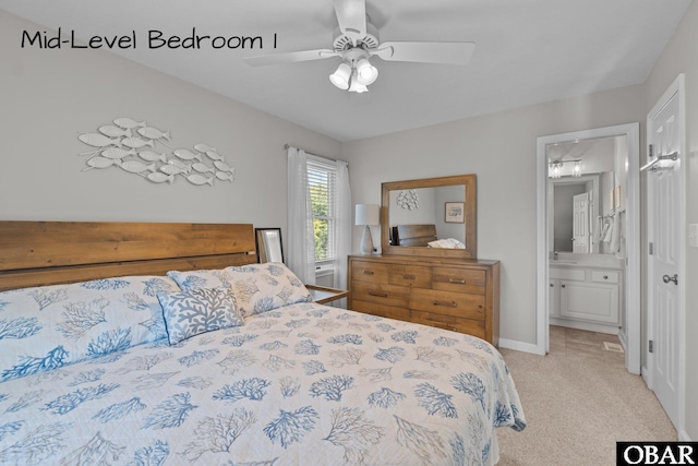 bedroom featuring ensuite bath, baseboards, carpet flooring, and ceiling fan