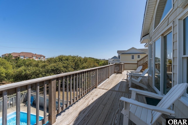 deck featuring a fenced in pool
