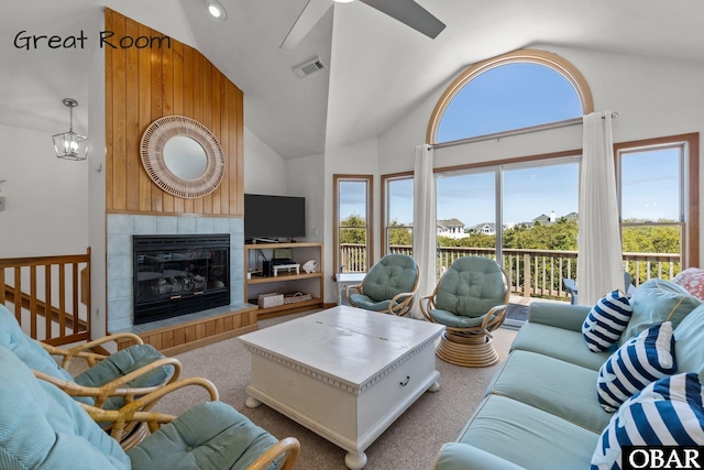 carpeted living area with high vaulted ceiling, a fireplace, visible vents, and ceiling fan