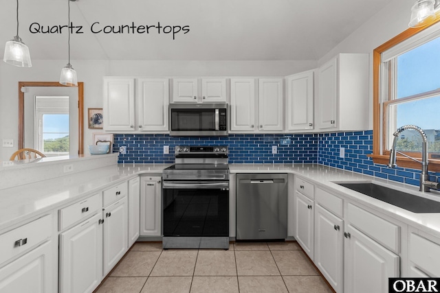 kitchen with stainless steel appliances, tasteful backsplash, and a sink