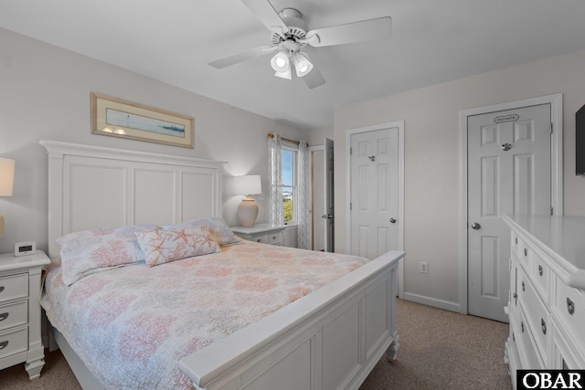 bedroom featuring ceiling fan and dark colored carpet