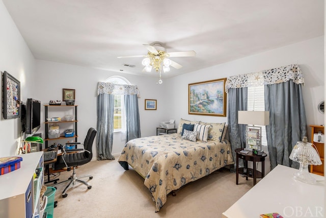 bedroom with light carpet, ceiling fan, and visible vents