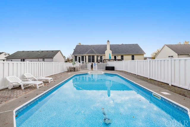 view of pool featuring a patio area, a fenced backyard, and a fenced in pool