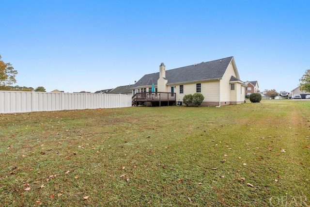 view of yard with fence and a wooden deck