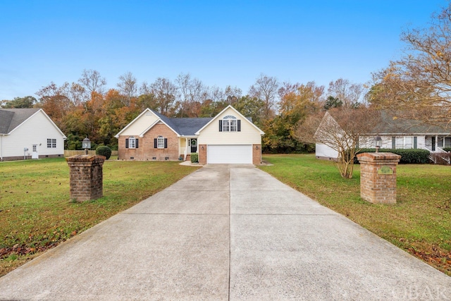 view of front of property featuring a front lawn, concrete driveway, and brick siding