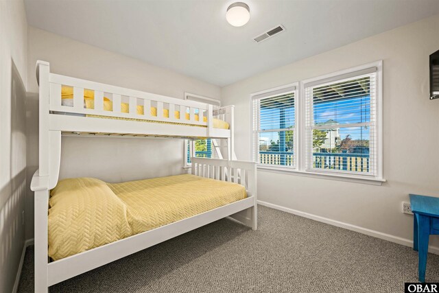 carpeted bedroom featuring visible vents and baseboards