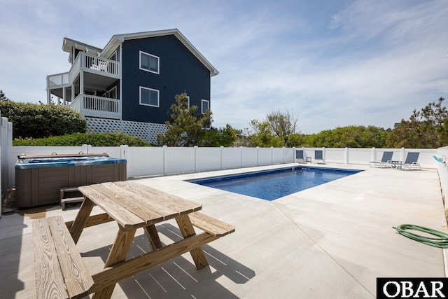 view of pool with a hot tub, a fenced in pool, a fenced backyard, and a patio