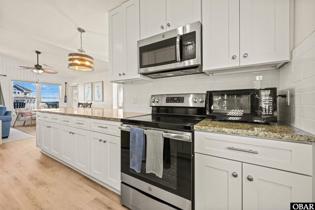 kitchen featuring appliances with stainless steel finishes, light wood-type flooring, and white cabinetry