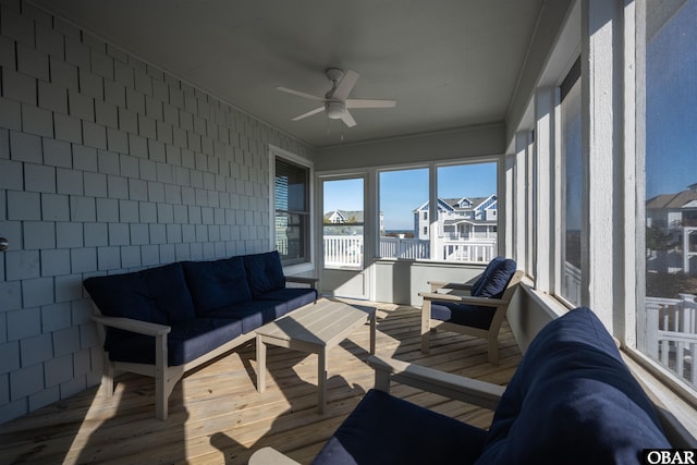 sunroom featuring ceiling fan