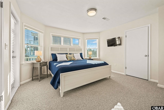 carpeted bedroom with visible vents and baseboards