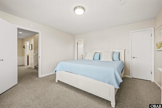 carpeted bedroom featuring baseboards and visible vents